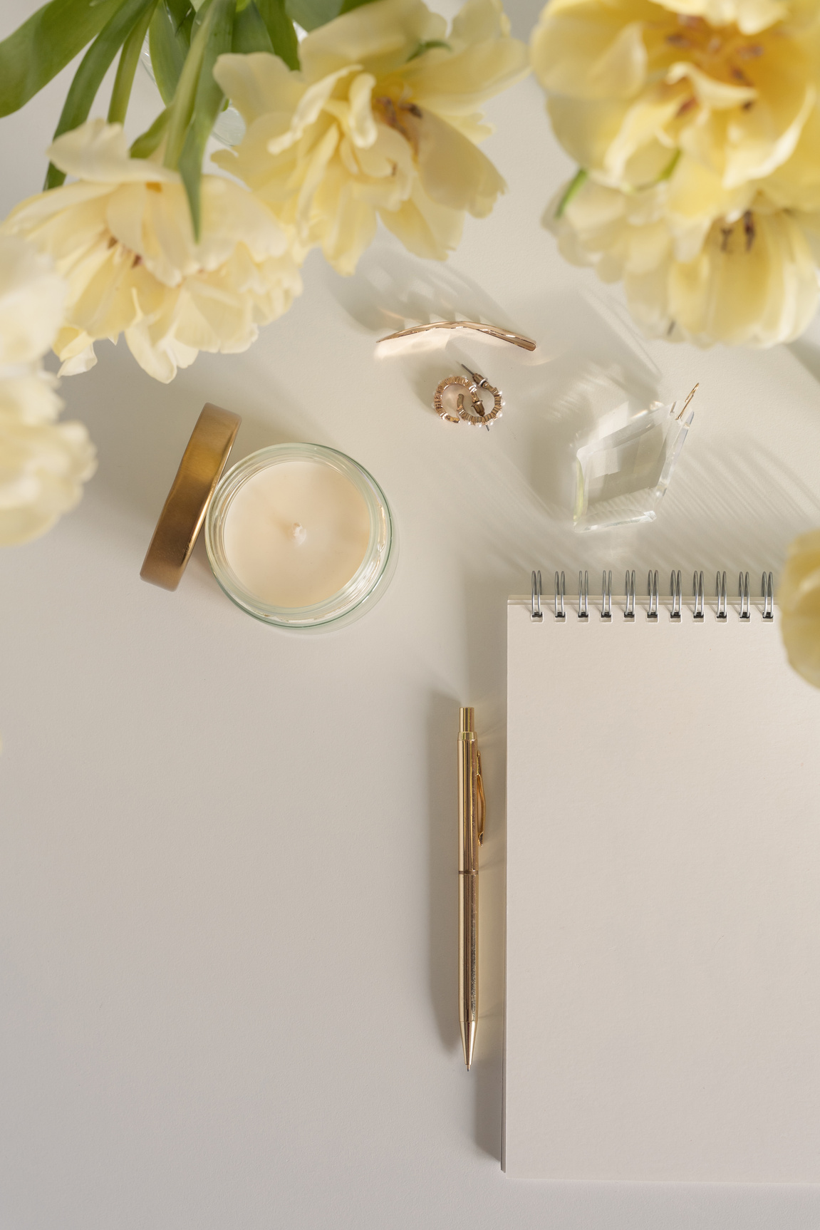 Aesthetic and light spring desk flat lay with yellow tulips, copy space